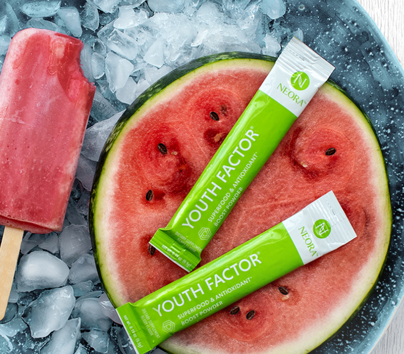 Neora Youth Factor® Superfood & Antioxidant (Powder) pictured with watermelon